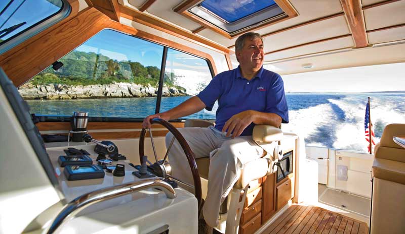 Bentley Collins arrived at Sabre in 1993 and helped catapult it from the brink of failure into a premier U.S. builder. Here he is at the helm of a Sabre 34. Photo courtesy Sabre/Back Cove Yachts